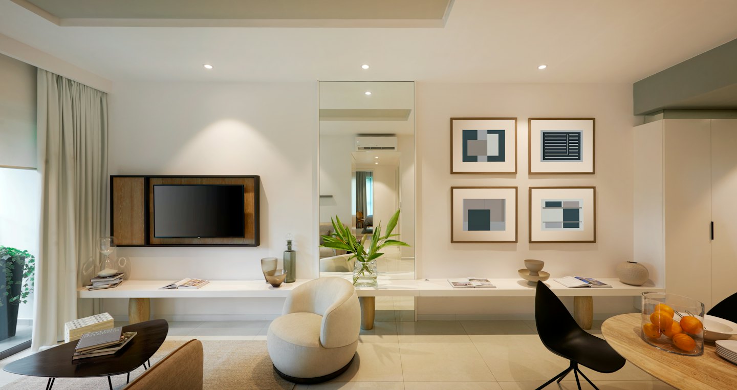 Modern living and dining area with white walls and wooden accents.